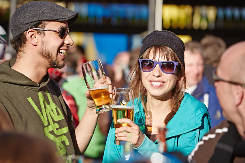 Etwas trinken beim Après Ski in St. Anton Pärchen trinkt Bier während Aprés Ski in St. Anton am Arlberg